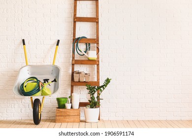 Set Of Gardening Supplies Near Brick Wall