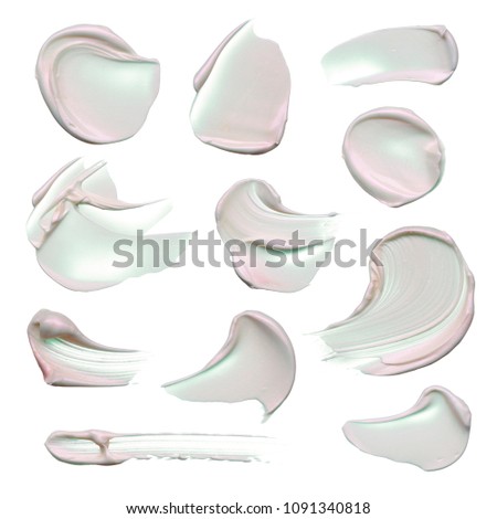 Set of gently pink, pearlescent makeup cream on a white background