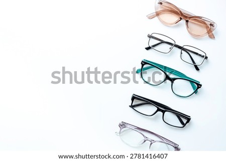Set of glasses with different frame in optics store. Eyesight and vision concept