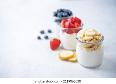 Set Of Greek Yogurt Strawberry Blueberry Banana Parfait In Jars. Toning. Selective Focus