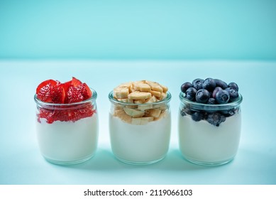 Set Of Greek Yogurt Strawberry Blueberry Banana Parfait In Jars. Toning. Selective Focus