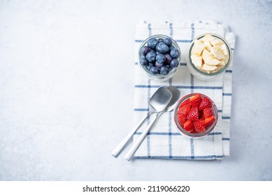 Set Of Greek Yogurt Strawberry Blueberry Banana Parfait In Jars. Toning. Selective Focus