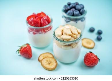 Set Of Greek Yogurt Strawberry Blueberry Banana Parfait In Jars. Toning. Selective Focus