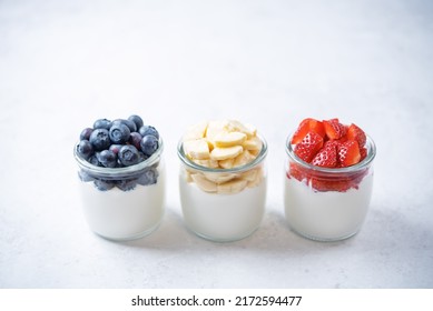 Set Of Greek Yogurt Strawberry Blueberry Banana Parfait In Jars. Toning. Selective Focus