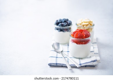 Set Of Greek Yogurt Strawberry Blueberry Banana Parfait In Jars. Toning. Selective Focus