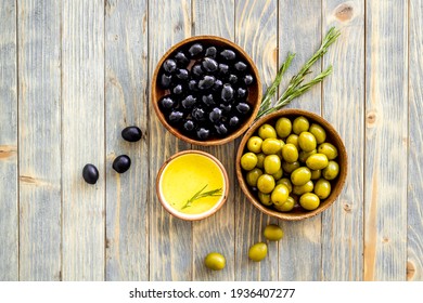 Set Of Green And Black Olives With Oil In Bowls. Top View