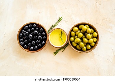 Set Of Green And Black Olives With Oil In Bowls. Top View