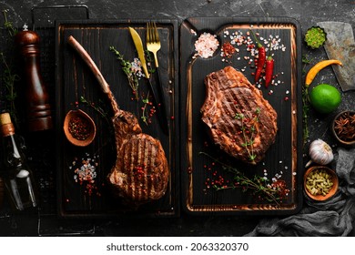 Set Of Grilled Veal Steaks On A Black Background, Top View