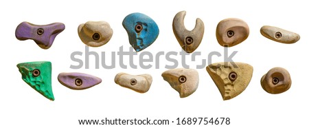 Set of grips different colors and shapes for climbing wall isolated on white background