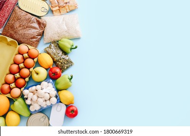Set of grocery items from canned food, vegetables, cereal on blue background. Food delivery concept. Donation concept. Top view. Copy space - Shutterstock ID 1800669319