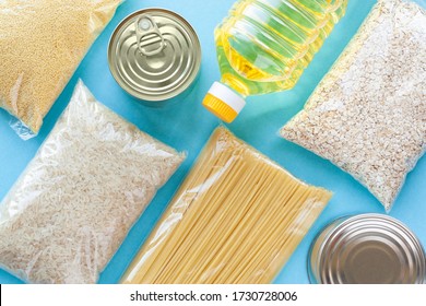 Set of grocery items from pasta, rice, oatmeal, couscous, oil and canned food on blue background. Food delivery, donation or stock provision concept. Top view, flat lay. - Shutterstock ID 1730728006