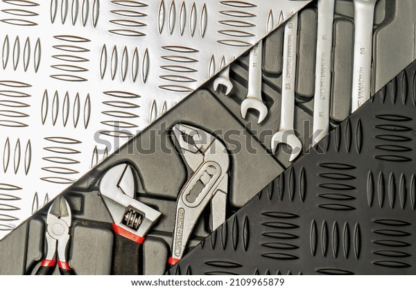 A set of hand tools for car repair in a perforated\
metal frame.