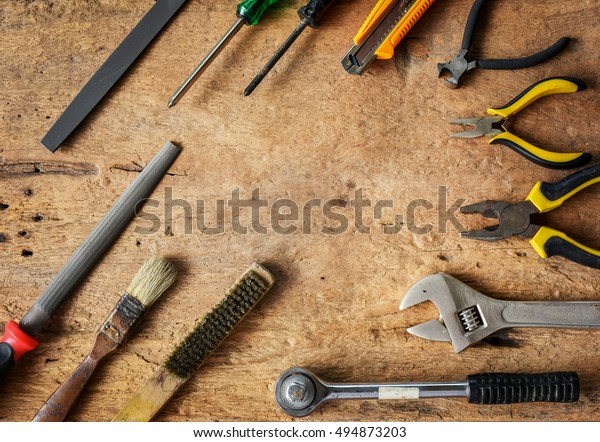   Set of hand tools\
in workshop on wood  background.  Hand tools for general work and\
home maintenance.  
