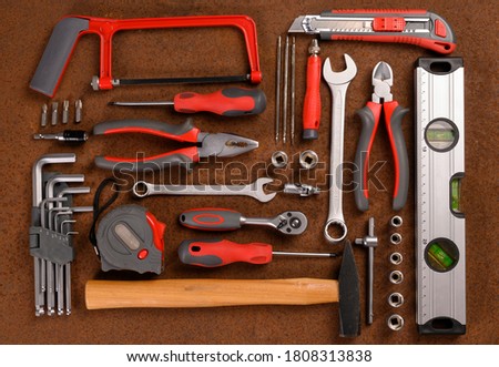 Set of hand various work tools on rusty background. Top view.