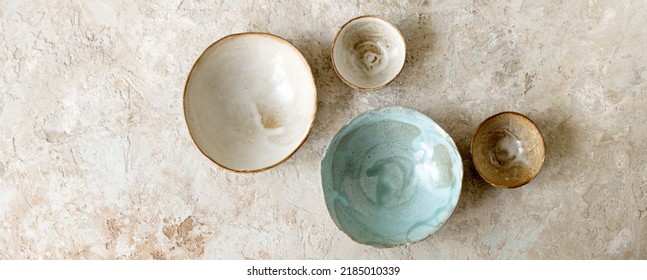 A Set Of Handmade Ceramic Bowls On A Light Table