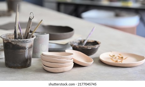 Set Of Handmade Ceramic Crockery On Table In Creative Studio Or Potter Store