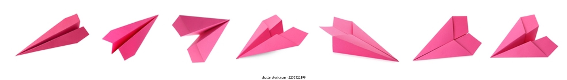 Set with handmade pink paper planes on white background