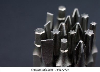 Set of heads for screwdriver (bits) Tools collection copy space, close up, selective focus. blurred dark background