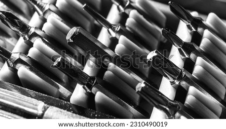 Set of heads for screwdriver bits. Tools collection copy space, close up, selective focus. blurred dark background