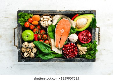 Set of healthy food in a wooden box: vegetables, fruits, fish, meat, nuts and herbs. Top view. Free copy space. - Powered by Shutterstock
