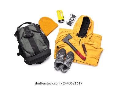 Set of hiking essentials with backpack, raincoat and outdoor gear on white background
