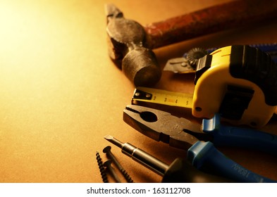 Set Of Home Maintenance Tools Arranged In A Semi-circle To The Right Of The Frame With Copyspace In Sepia Toned Lighting