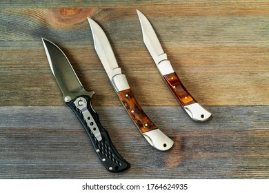 set of hunting knives on wooden background