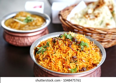Set of Indian food. Biryani in the front bowl. Curry and naan bread at the back. Indian cuisine consists of a wide variety of regional and traditional cuisines native to the Indian subcontinent. - Powered by Shutterstock