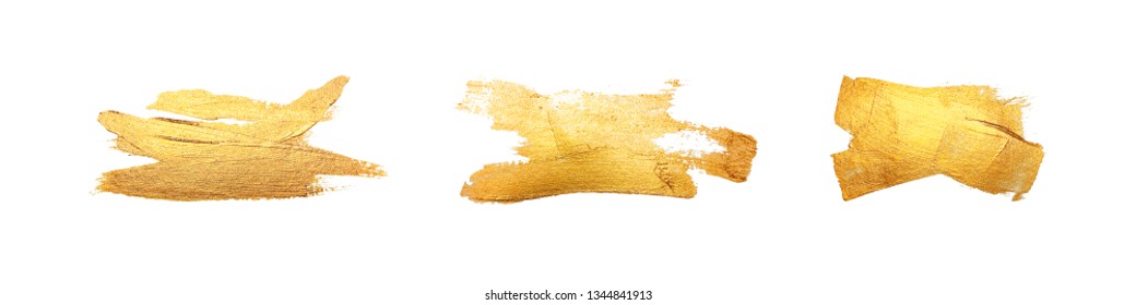 Set of isolated brush strokes with gold paint on a white background. Golden smear.