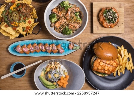 Set of japanese food dishes on woodenbackground, top view