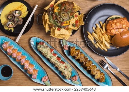 Set of japanese food dishes on woodenbackground, top view