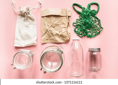 Set of jars and paper bag on pink background for zero waste storage and shopping. View from above. No Plastic.