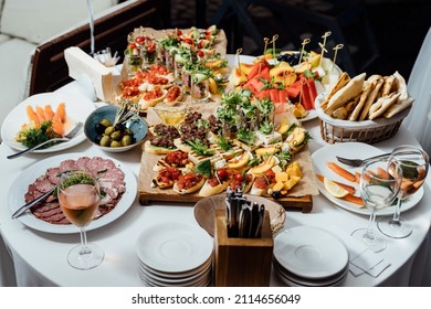 A set of juicy servings of steak, cheese platter, healthy vegetable platter, meat, sandwiches, fruits, carpaccio and tartare. Healthy food - Shutterstock ID 2114656049