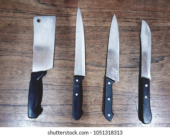 Set of kitchen knifes on old wooden table.