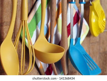 Set of kitchen tools hanging on the wall.