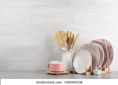 Set of kitchenware on table near light wall, space for text. Modern interior design - Shutterstock ID 1450345538
