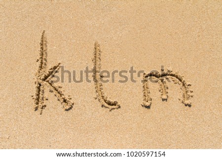 Set of klm letters of alphabet written on sand with lower case.