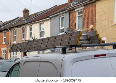 A Set Of Ladders On The Roof Of A Builders Van