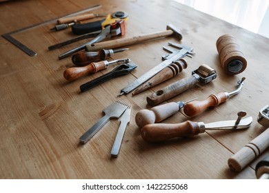 Set Of Leather Craft Tools On Wooden Background. Leather Crafting Tools Still Life.