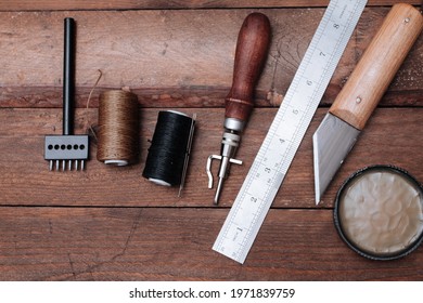 Set of Leather crafting tools. Shoes maker tools on wooden table - Powered by Shutterstock