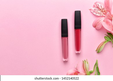 Set of lipglosses on color background