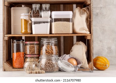 Set of long storage term foods on pantry shelf prepared for disaster emergency conditions on brick wall background