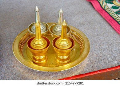 Set for to make a libation. golden brass bottle to pouring water into bowl for dedication to dead person, part of merit in buddhism. Traditional and culture of Thailand.