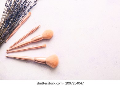 Set of makeup brushes on light background