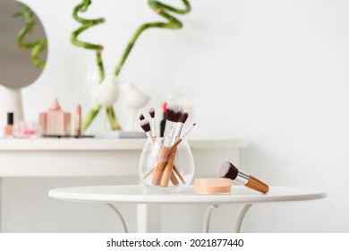 Set of makeup brushes on table