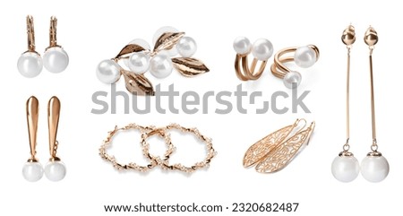 Set of many different golden earrings isolated on white