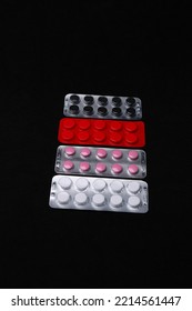 Set Of Medical Tablets And Pills In Pharmaceutical Blister Pack On Black