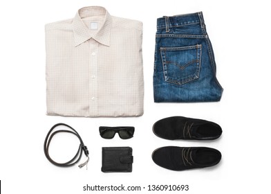 Set Of Mens Clothing And Accessories On A White Background. Shirt, Jeans, Boots, Purse, Sunglasses And A Belt. Flat Lay. Top View. 