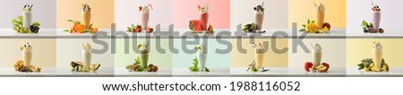 Set of milk shakes with cream in tall glass glass decorated with fruits of various flavors on white table and isolated colored background. Front view.