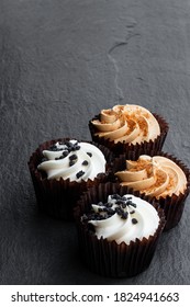 Set of  mini cupcakes on black stone background 